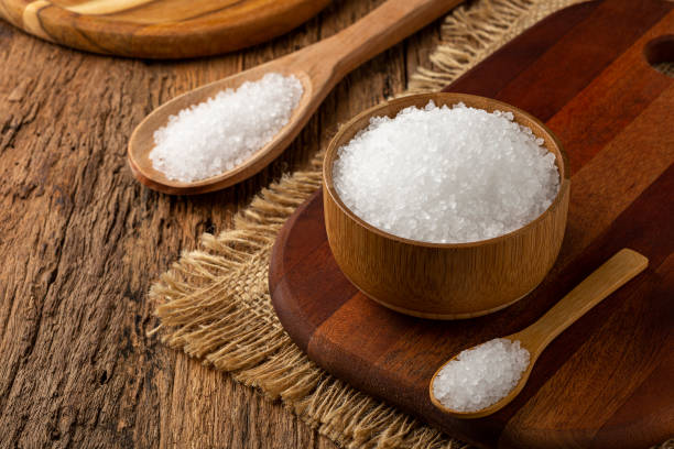 istock Coarse salt in bowl on wooden background. 1345387761