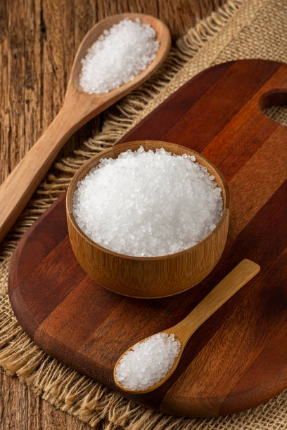 istock Coarse salt in bowl on wooden background. 1345388284