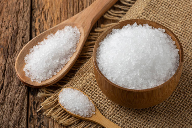 istock Coarse salt in bowl on wooden background. 1345388287