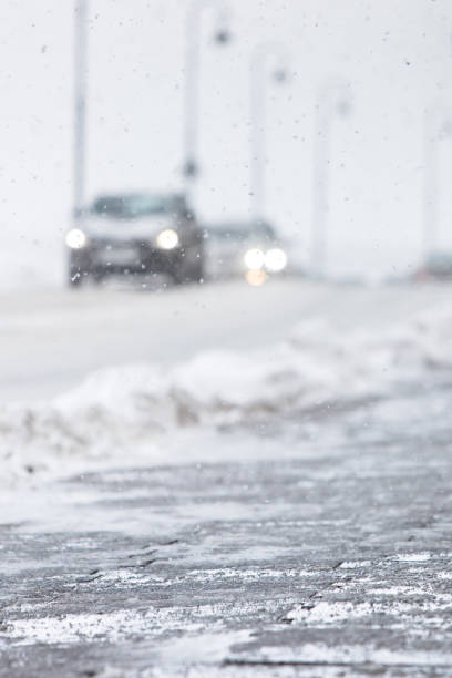 istock De-icing chemicals on the winter road, selective soft focus. Pavement is sprinkled with technical salt or salt mixtures based on it. 1345391656