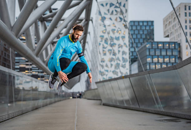 istock Athlete men jumping at the bridge 1345392397
