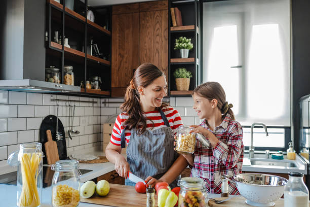 istock Having fun while preparing healthy meal with mother in the kitchen 1345392605