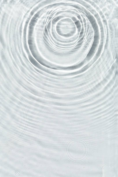istock Abstract water texture, surface with drops, rings and ripple. 1345392612