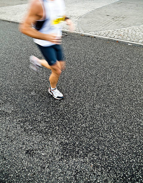 istock Man running in city marathon, motion blur 134539565