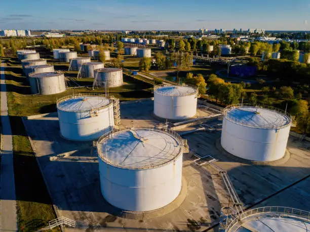 Photo of Petrol industrial zone. Aerial view of round tanks