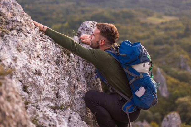 istock Success man hiker hiking on sunrise mountain peak 1345396883