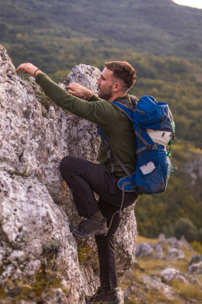 istock Success man hiker hiking on sunrise mountain peak 1345396892