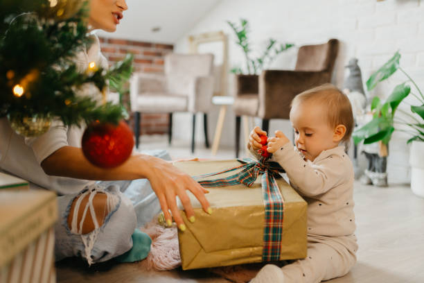 istock Mother and daughter unpacking Christmas gift 1345398671