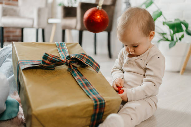 istock Mother and daughter unpacking Christmas gift 1345398676