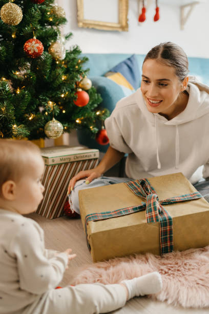 istock Mother and daughter unpacking Christmas gift 1345398680