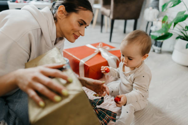 istock Mother and daughter unpacking Christmas gift 1345398722