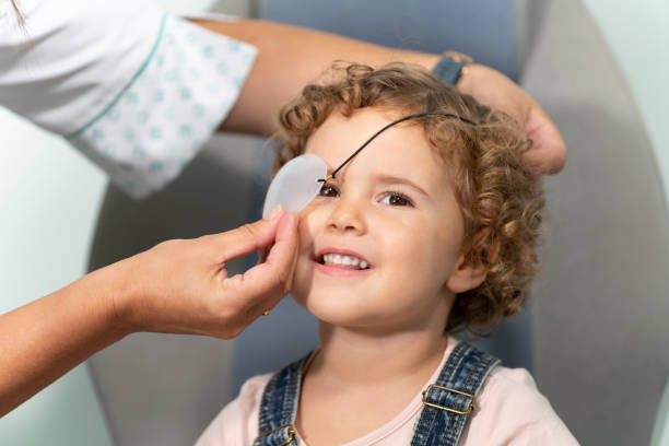 Little girl with a patch at an optometrist consultation Little girl with a patch at an optometrist consultation. Curly hair one eyed stock pictures, royalty-free photos & images