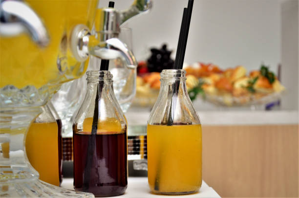 istock Grape and orange juice in bottle with black straw 1345405805