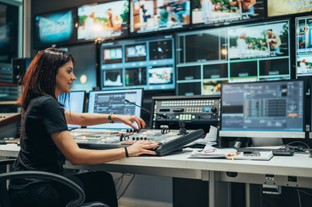 Young beautiful woman working in a broadcast control room on a tv station Young beautiful woman working in a broadcast control room on a tv station performing arts event stock pictures, royalty-free photos & images