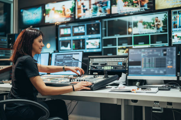 young beautiful woman working in a broadcast control room on a tv station - broadcasting imagens e fotografias de stock