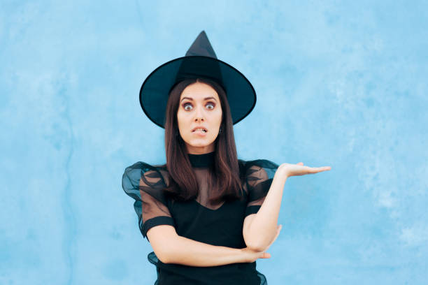istock Woman Wearing Witch Costume Presenting with Hand Gesture 1345406065