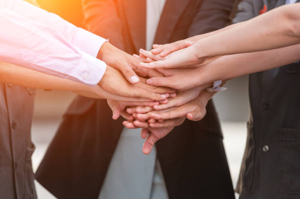 istock business people team stacking hands and teamwork concept. 1345407580