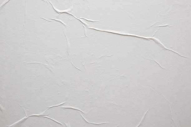 istock Blank white crumpled and creased paper poster texture background 1345408381