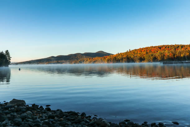 Moosehead Lake, Maine, on a calm early Fall morning Moosehead Lake, Maine, on a calm early Fall morning showing some fall foliage mt katahdin stock pictures, royalty-free photos & images