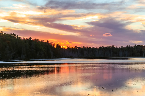 Spectacle Pond near Moosehead Lake, Maine, at sunset with beautiful cloudscape colors