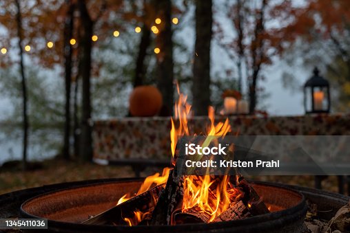 istock Glowing campfire at autumn campsite 1345411036