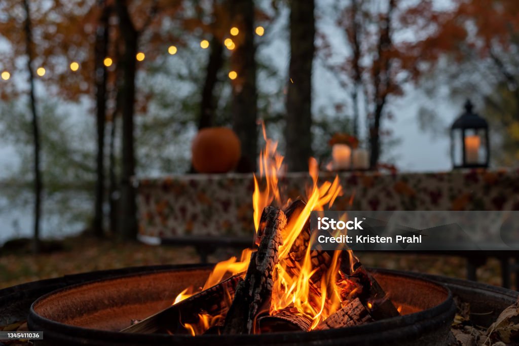 Glowing campfire at autumn campsite Closeup of glowing outdoor campfire in fall Fire Pit Stock Photo