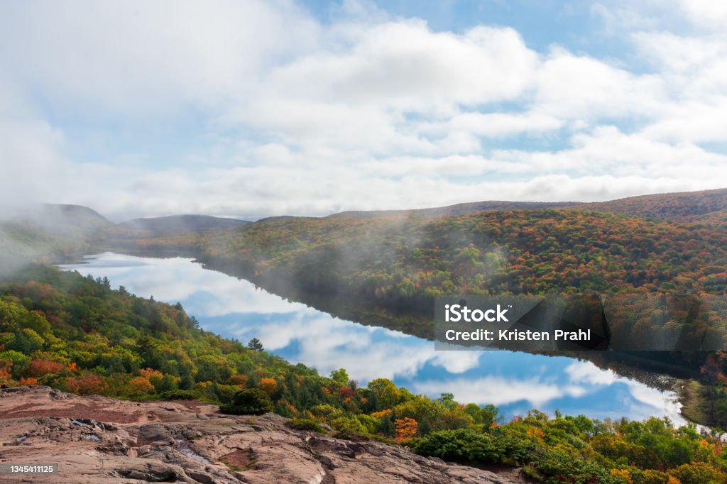 Clouds reflecting in mountain lake in autumn Beautiful autumn landscape with clouds reflecting in mountain lake Autumn Stock Photo