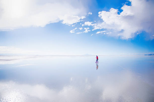 Walking women in salt flat Salar de Uyuni, Bolivia Walking women in salt flat Salar de Uyuni, Bolivia salar de uyuni stock pictures, royalty-free photos & images