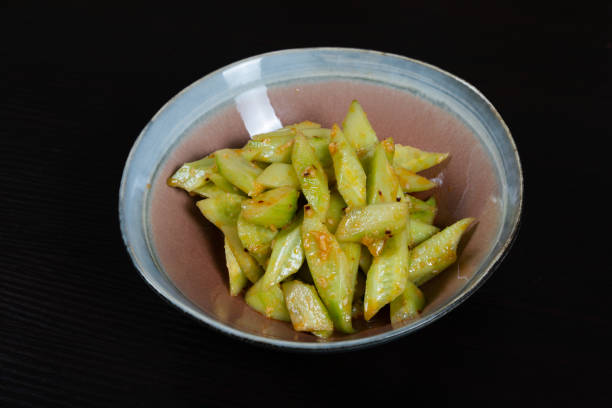 istock Salad with chopped cucumbers in garlic sauce on a black background 1345423866