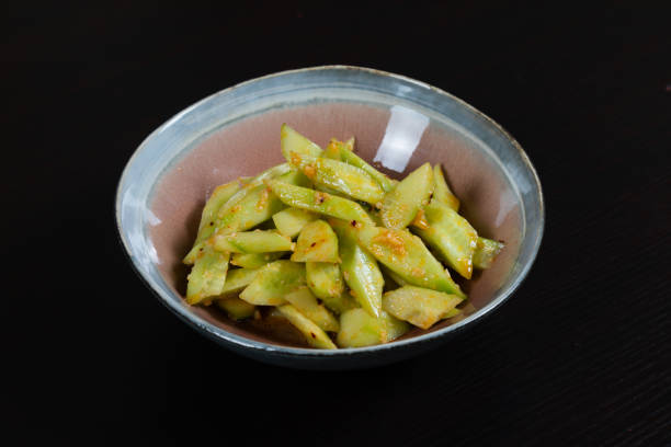 istock Salad with chopped cucumbers in garlic sauce on a black background 1345423910