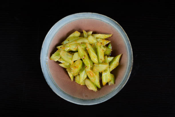 istock Salad with chopped cucumbers in garlic sauce on a black background 1345423925