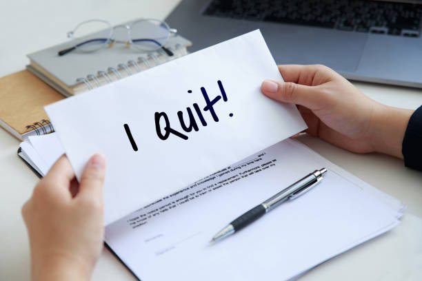 Close up woman hands holding a piece of paper of I quit the job. Quit Job Motivation aspiration Concept. stock photo