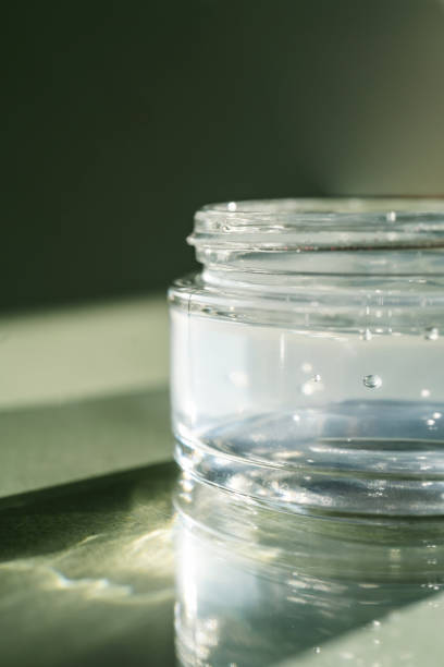 istock Transparent gel in a jar on a green background. 1345426539