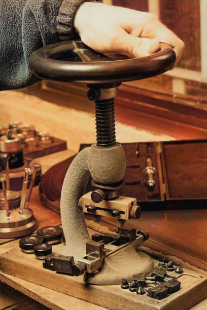 istock Male hand resting on a vintage rotary bench press on a workbench 1345429435