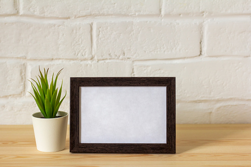 mock up empty photo frame on table or shelf with copy space