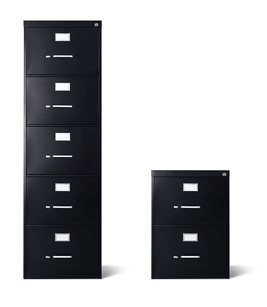 Tall and Short Black Filing Cabinets Isolated A large balck filing cabinet with five drawers stands next to a two drawer small filing cabinet isolated over 100% white background with cast shadow. Each have a precise clipping path. Canon 5D MarkII DSLR. filing cabinet stock pictures, royalty-free photos & images