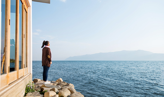 Woman standing by the lake.