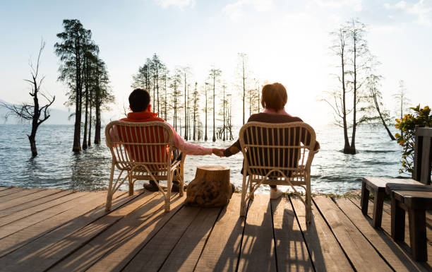 istock Couple sitting in chairs by the lake 1345435049