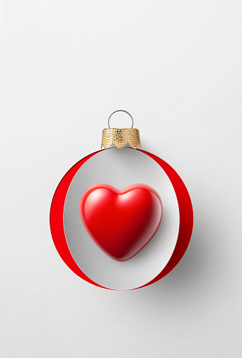 Paper Christmas ball with heart isolated on a white background.