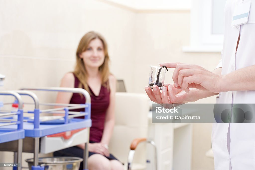 Hirudotherapy Medical blood sucking leech in hands of doctor in laboratory Blood Stock Photo