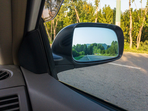 Car side mirror reflection landscape view