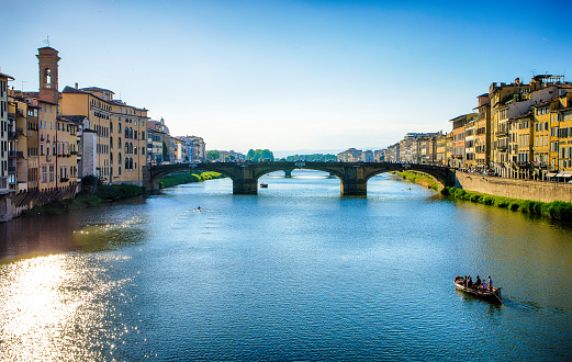 River Arno and tour boat in Florence, Italy