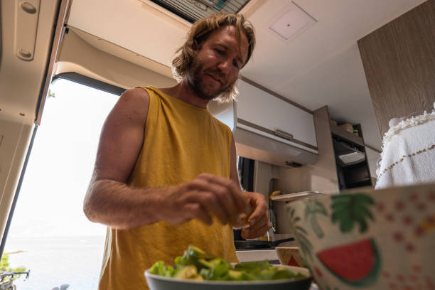 istock Man cooking in a van, healthy salad 1345439382