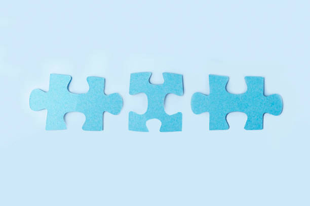 istock Blue jigsaw puzzle pieces on yellow background. Teamwork  logical thinking. Concept of solutions, mission, success, goals, cooperation and partnership. Copy space for text 1345440136