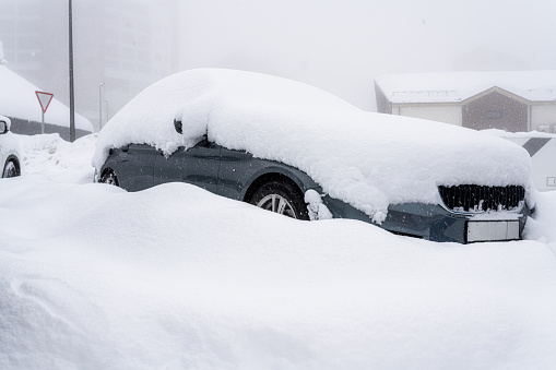 Snow-covered car on a parking