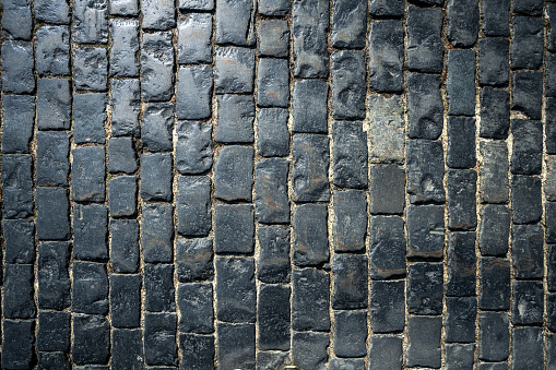 Stone pavers in city park. Paving stones for walkways and sidewalk. Outdoor surface. Abstract background.