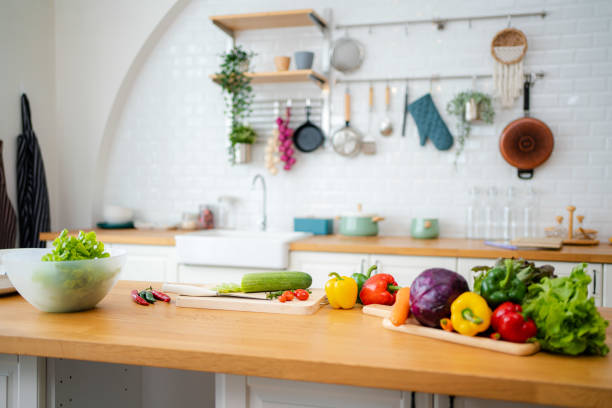 istock Kitchen table with vegetables and cutting board for preparing salad . 1345445202