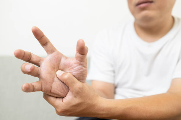 istock Asian middle-aged man patient suffering from numbing pain in hand,arthritis,tendon problem causing a finger to jerk,trigger finger disease,stiffness of the joints,massage his palms,health care concept 1345447393