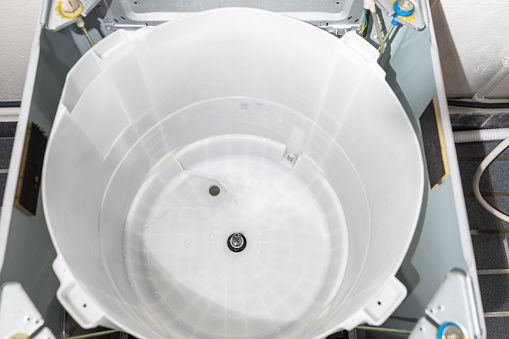 Inside of the washer drum is completely clean,free from dirt stains and musty odors,empty tub of a washing machine,household electrical appliances,cleaning services,cleanliness and hygienic concept