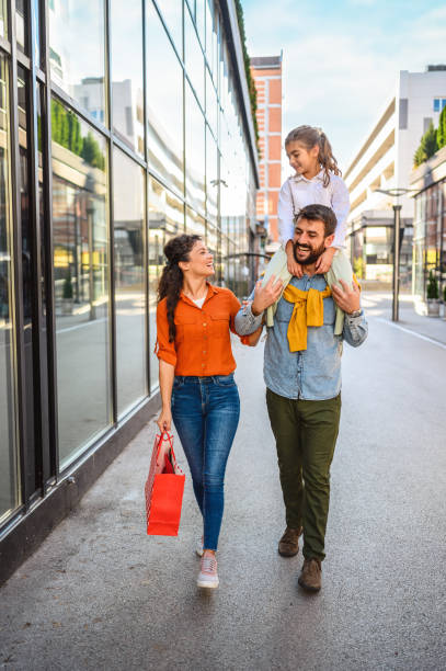 istock Young cheerful family in shopping. 1345448347